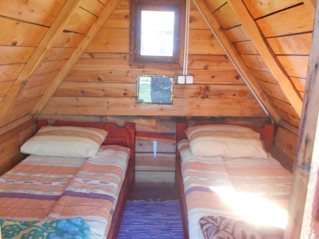 two beds in the attic of a log cabin at Etno selo - Guest House Etno Village - TRSA in Pluzine
