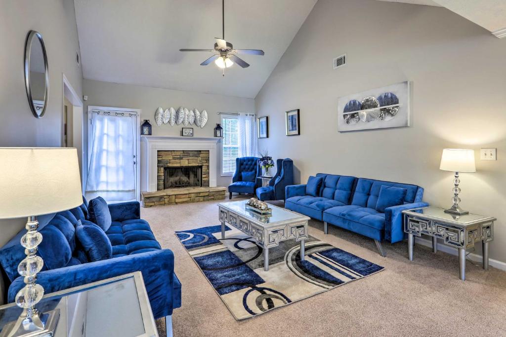 a living room with blue couches and a fireplace at Covington Abode Less Than 30 Mi to Stone Mtn Park! in Covington