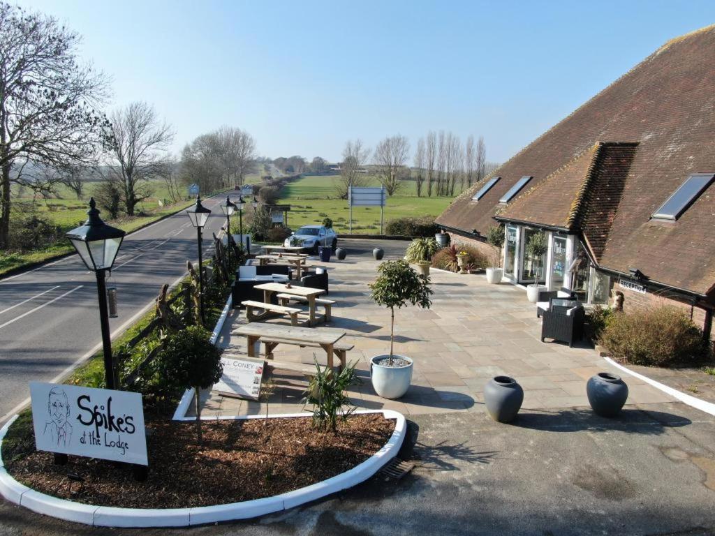 a picnic area with a picnic table and buildings at Winchelsea Lodge in Winchelsea