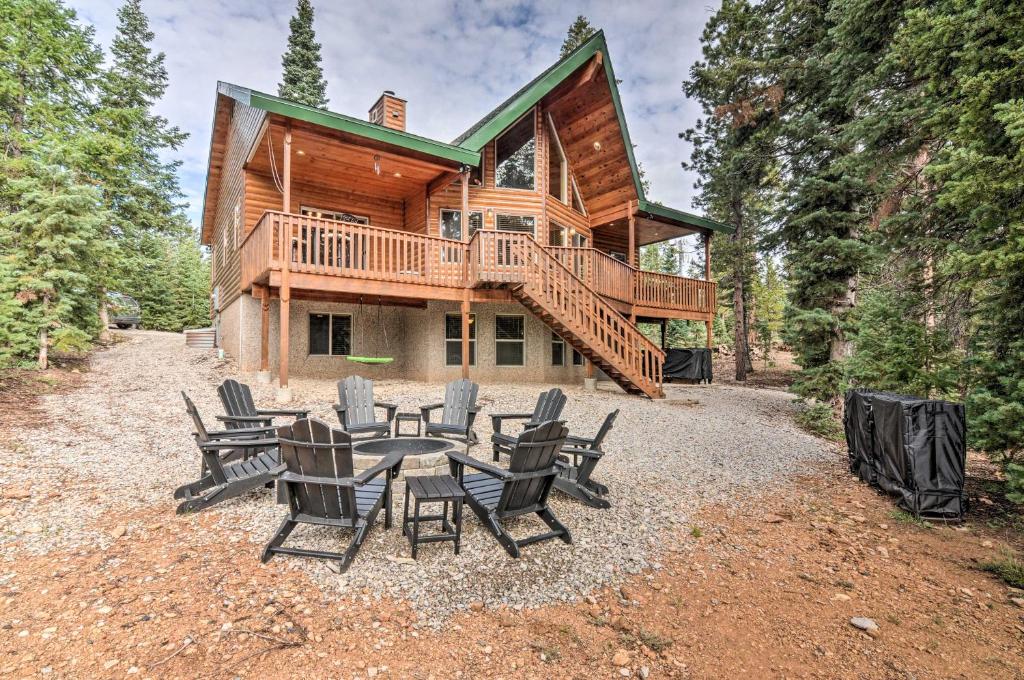 a house with a table and chairs in front of it at All-Encompassing Cabin with Fire Pit and Kayaks! in Duck Creek Village