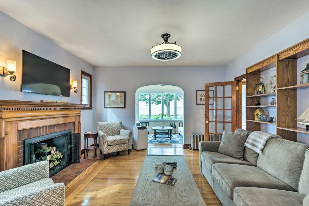 sala de estar con sofá y chimenea en Walkable New Haven Retreat with Ocean Views!, en New Haven