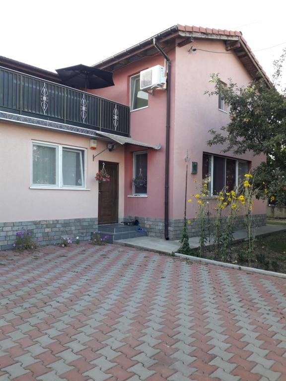a house with a brick driveway in front of it at Vila Roz in Mangalia