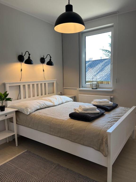 Posteľ alebo postele v izbe v ubytovaní Apartamenty Olimpijska 1B & 1T