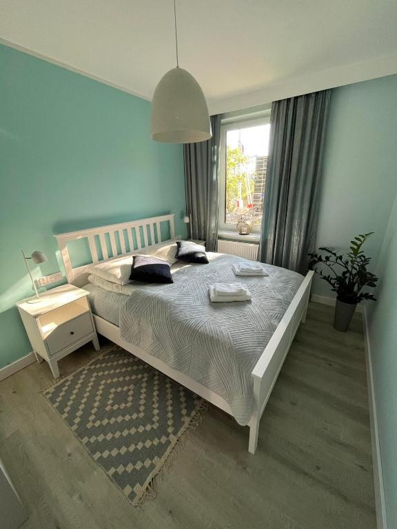 Posteľ alebo postele v izbe v ubytovaní Apartamenty Olimpijska 1B & 1T