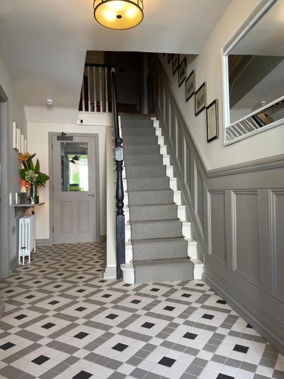 a staircase in a house with a checkered floor at Number 46 in Hastings