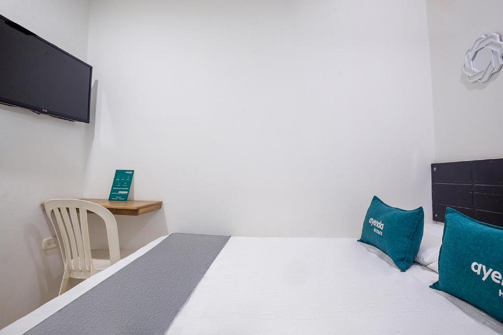 Postel nebo postele na pokoji v ubytování Ayenda Hotel Alejandría