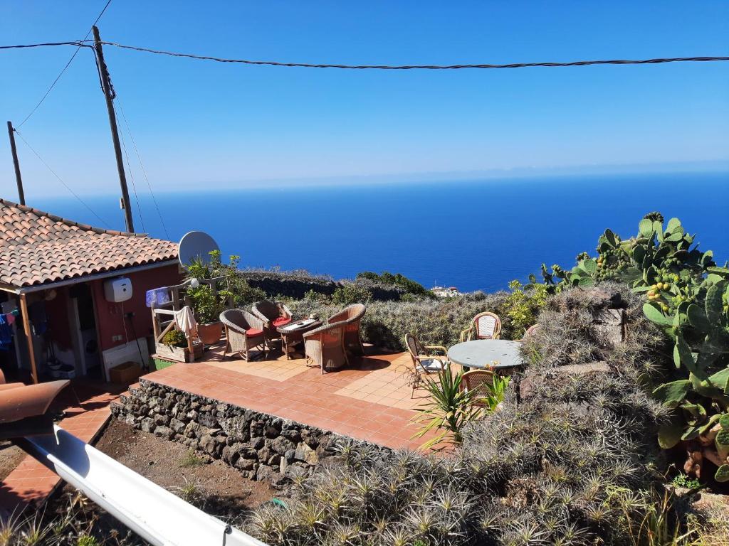 a house with a patio with a view of the ocean at Finca Lomo de Castillo - Kleines Schlösschen am Berg in Icod de los Vinos