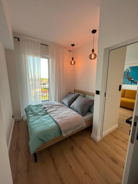 Postel nebo postele na pokoji v ubytování Apartament 4 piętro
