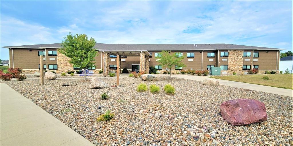 a building with a gravel yard in front of a building at Qube Hotel - Polk City in Polk City