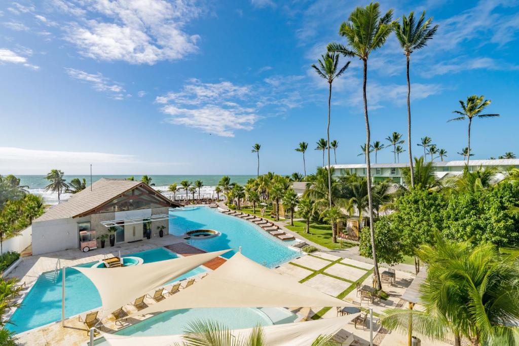 an aerial view of a resort with a pool and palm trees at The Westin Porto de Galinhas All-Inclusive in Porto De Galinhas