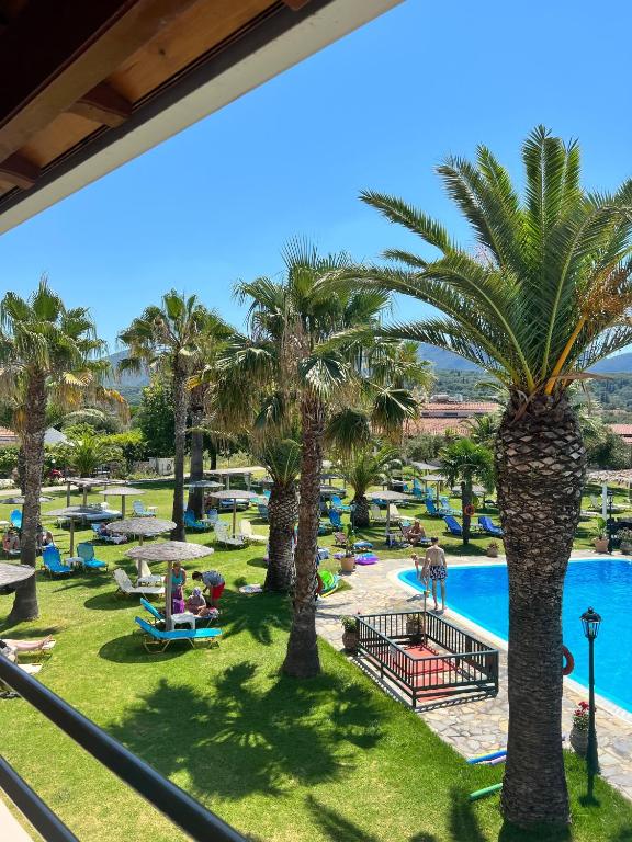 a view of a resort with palm trees and a pool at Elizabeth Roda in Roda