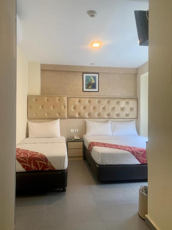 Postel nebo postele na pokoji v ubytování Sandpiper Hotel Singapore