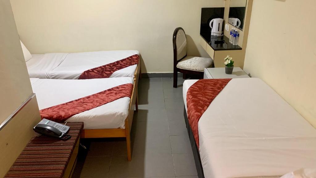 Postel nebo postele na pokoji v ubytování Sandpiper Hotel Singapore