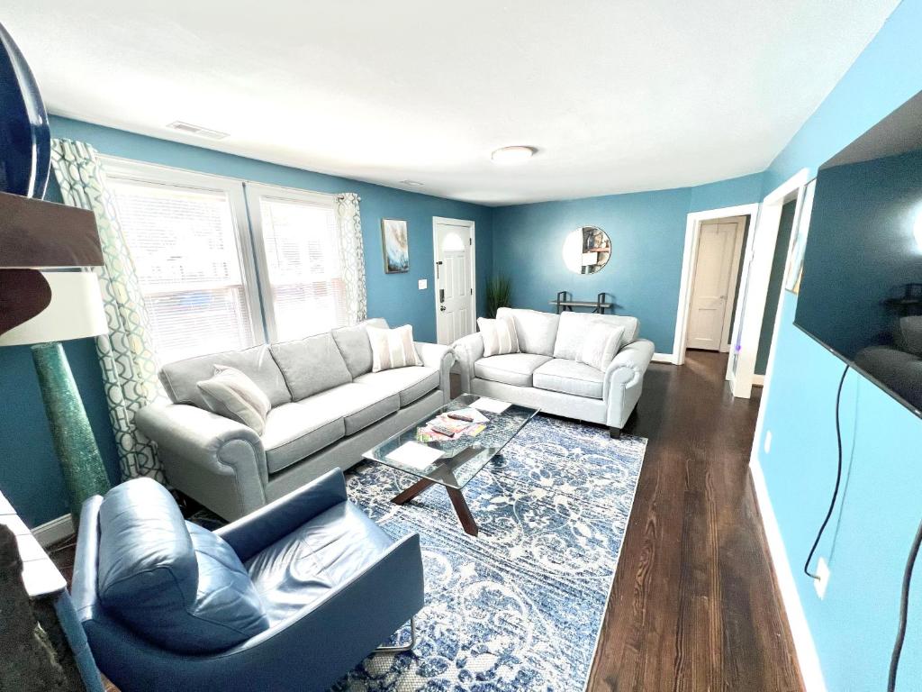a living room with blue walls and white furniture at The Absolute Best Home Away From Home Pet Friendly!!! in Wilmington