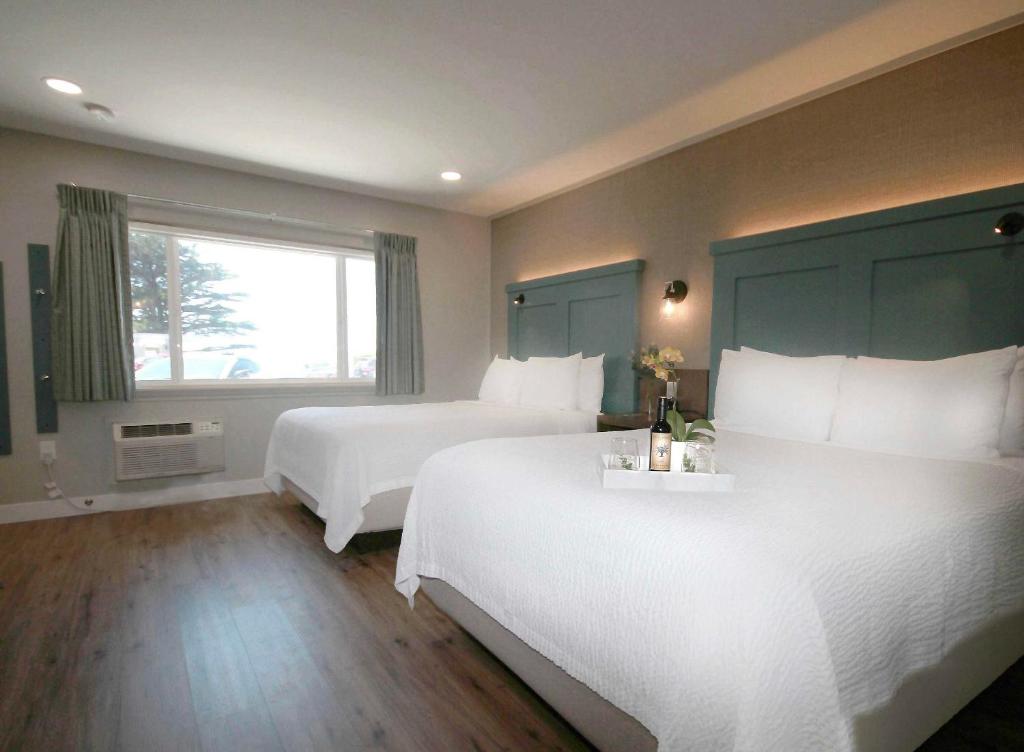 a hotel room with two beds and a window at Castle Inn in Cambria