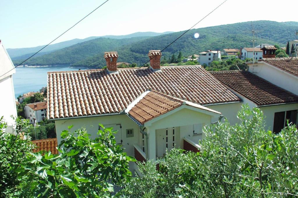 a white house with a view of the water at Apartments with WiFi Rabac, Labin - 2323 in Rabac