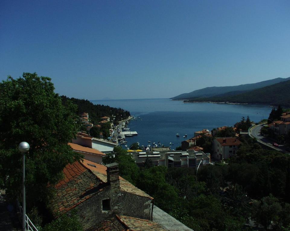 a view of a large body of water from a city at Apartment Rabac 2323b in Rabac