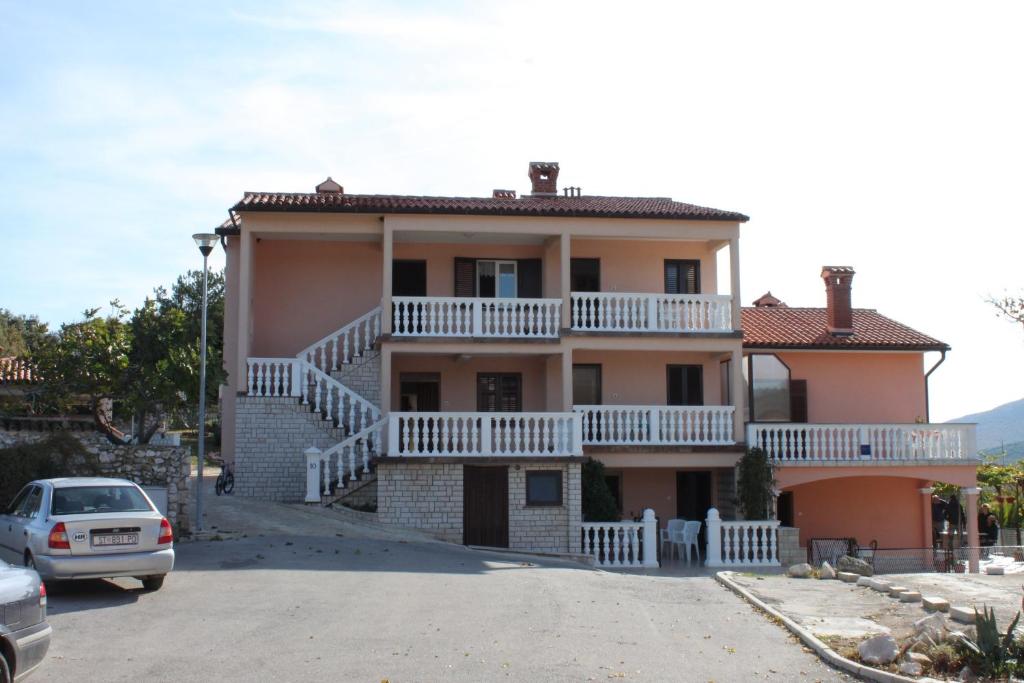 a house with a car parked in front of it at Apartments by the sea Duga Luka - Prtlog, Labin - 2367 in Drenje