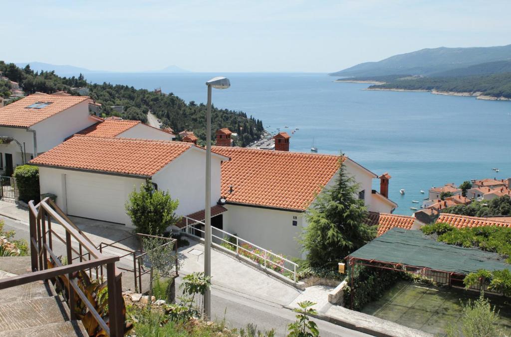 a group of houses with a view of the water at Apartment Rabac 2340a in Rabac