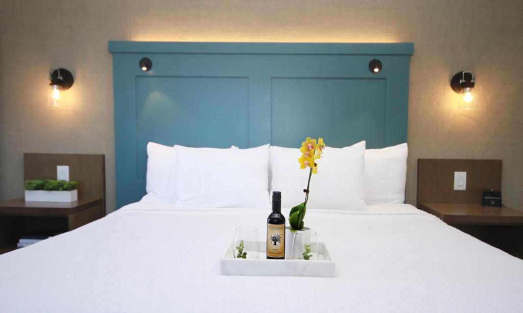a bed with a bottle of wine and flowers on it at Castle Inn in Cambria