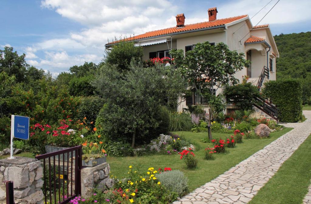 a house with a garden in front of it at Apartments with a parking space Smrika, Kraljevica - 2365 in Šmrika
