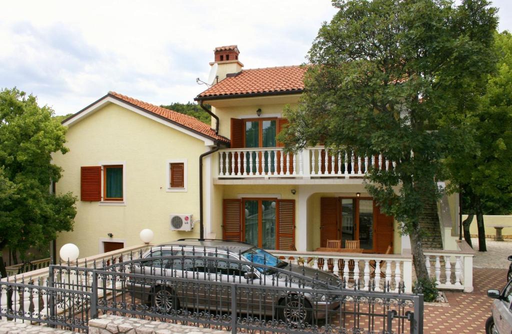 a house with a car parked in front of it at Apartments with a parking space Povile, Novi Vinodolski - 2398 in Povile