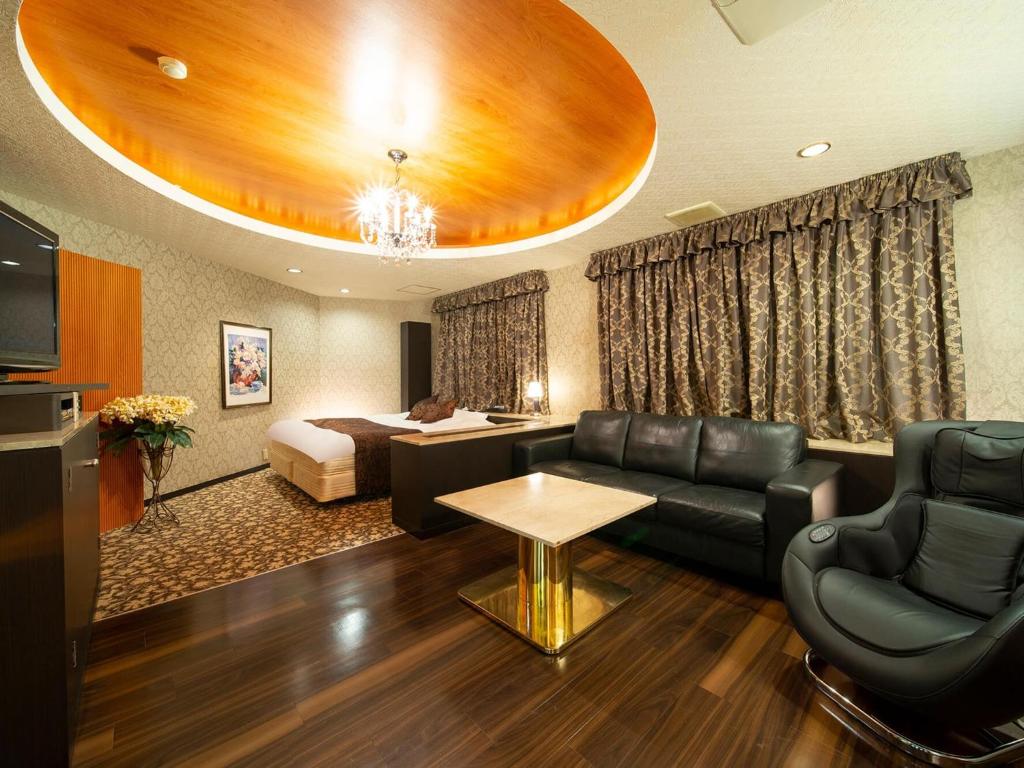 a hotel room with a couch and a bed at HOTEL U's Kouroen - Vacation STAY 11259v in Nishinomiya