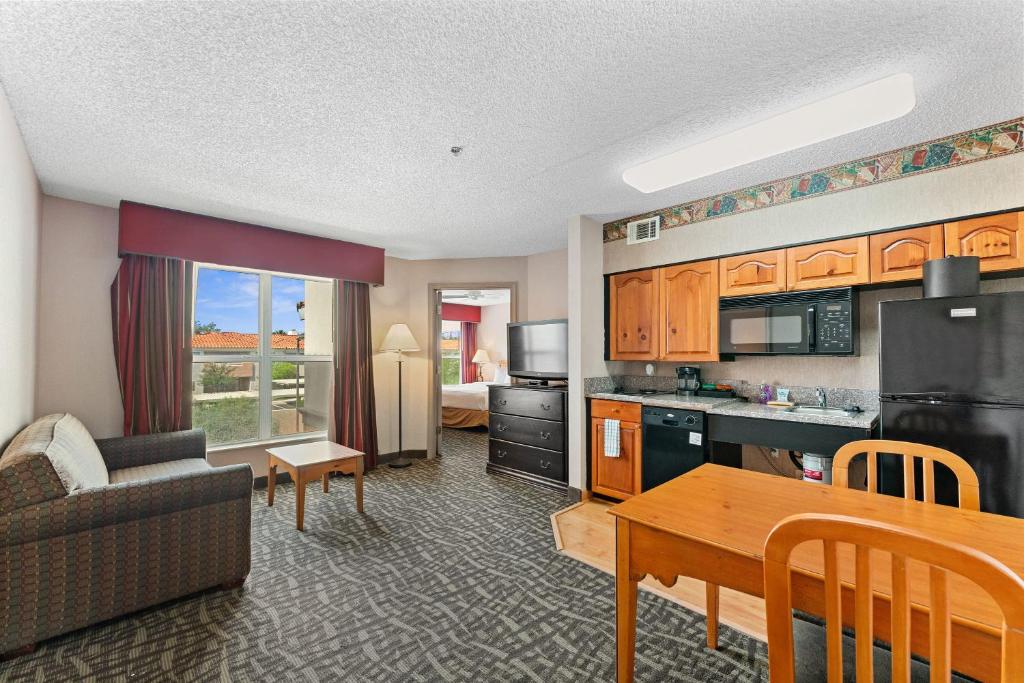 a kitchen and living room with a couch and a table at Scottsdale 2 bd 2 ba furnished apt King beds in Scottsdale