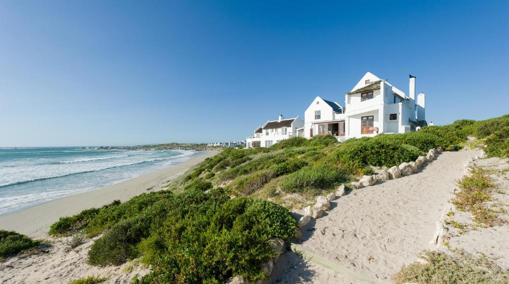 a house on a hill next to the beach at The Oystercatchers Haven at Paternoster in Paternoster