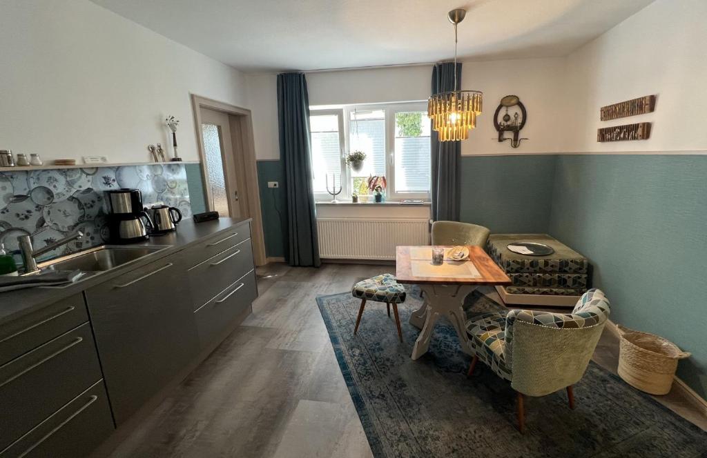 a kitchen with a table and a dining room at Apartment Siegfried in Bayreuth