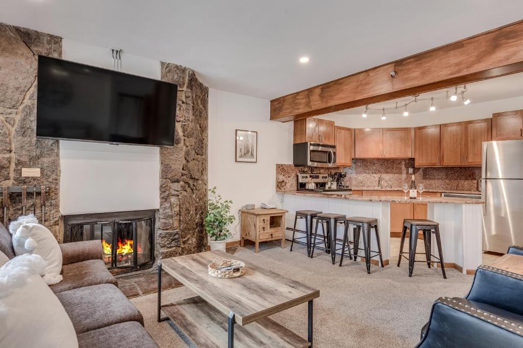 a living room with a couch and a fireplace at Laurelwood Condominiums 102 in Snowmass Village