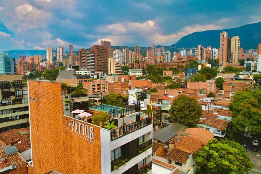 a cityscape of a city with tall buildings at Los Patios Hostel in Medellín