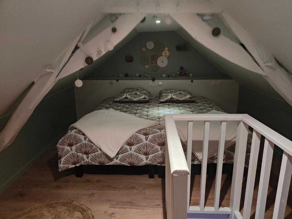 een slaapkamer met een bed op de zolder bij Four à pain in Torcé-en-Charnie
