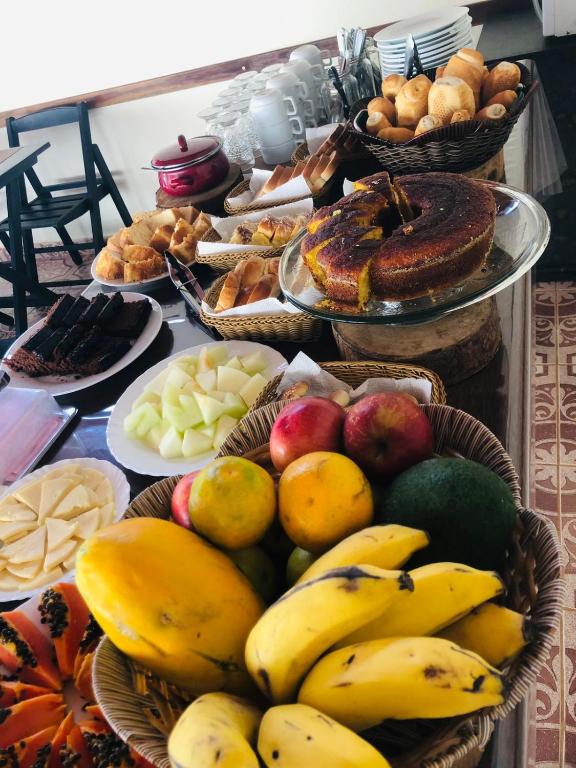 a table with baskets of fruit and other foods at Pousada Licuri in Serra do Cipo