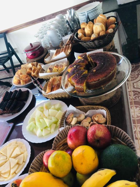a table topped with lots of different types of food at Pousada Licuri in Serra do Cipo