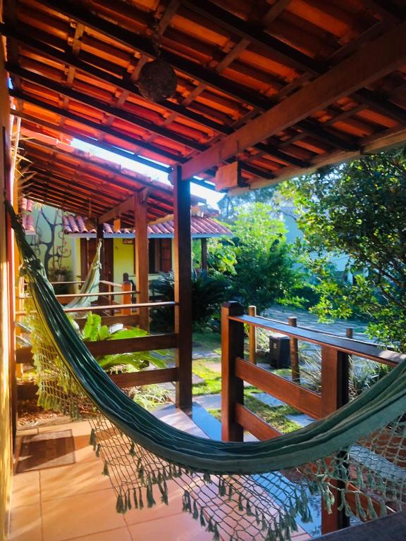 a hammock on a porch of a house at Pousada Licuri in Serra do Cipo