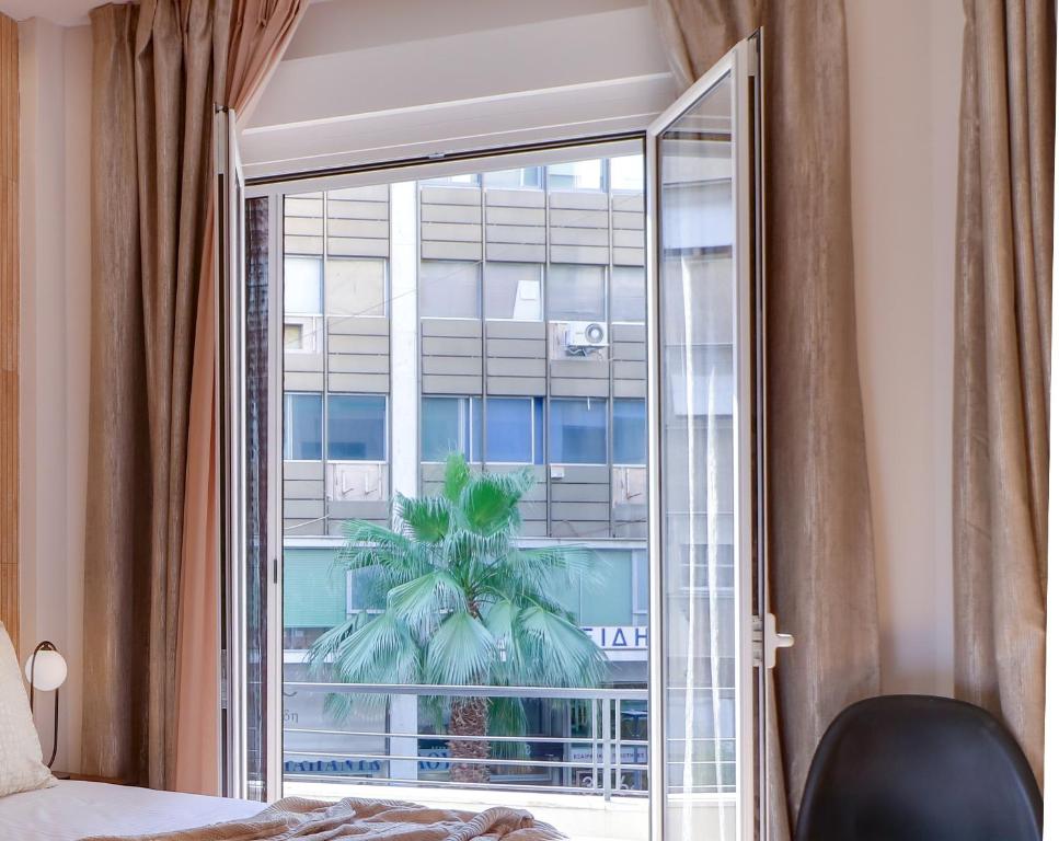 Postel nebo postele na pokoji v ubytování AthINN Residence