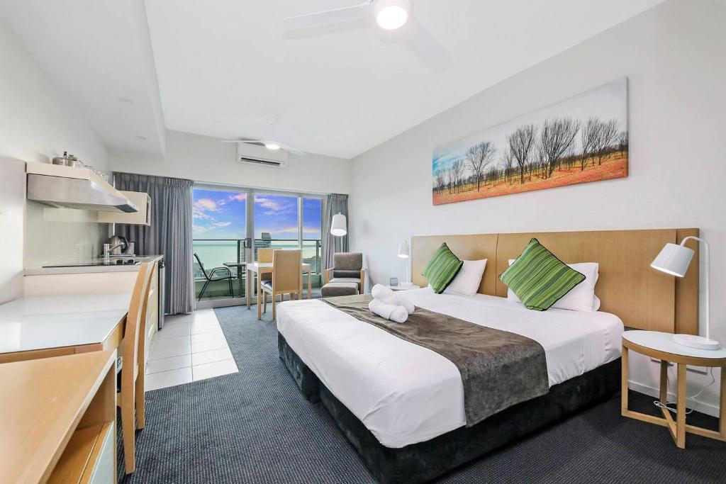 a hotel room with a large bed and a kitchen at '18th in the Clouds' CBD Resort Living with Pool in Darwin