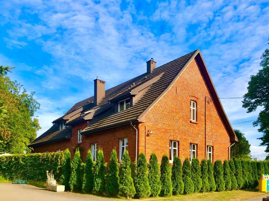 a red brick house with a black roof at Historical holiday home in Mielenko 400 m from the sea in Mielenko