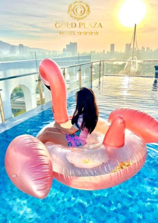 A rooftop pool scene with a child on a pink inflatable ring and a city skyline beyond.