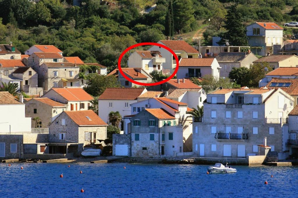 a red circle in the middle of a city with houses at Apartments with parking space Vis - 2436 in Vis