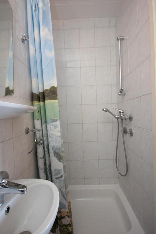 a bathroom with a sink and a toilet and a shower at Apartments and rooms by the sea Komiza, Vis - 2431 in Komiža