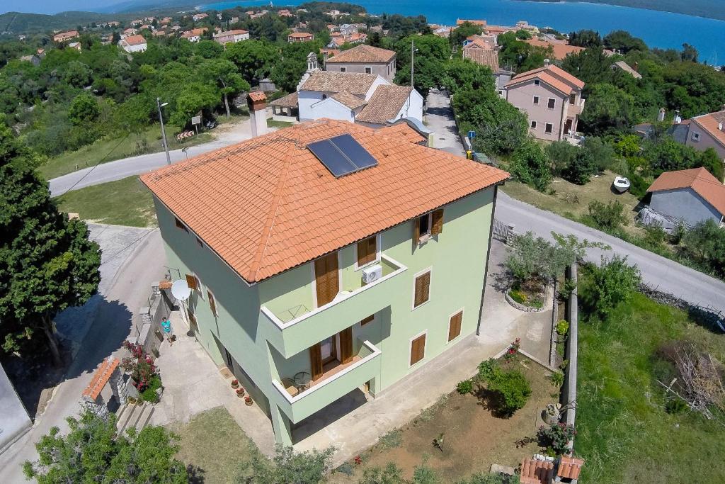 an aerial view of a house with an orange roof at Apartments and rooms with parking space Nerezine, Losinj - 2506 in Nerezine