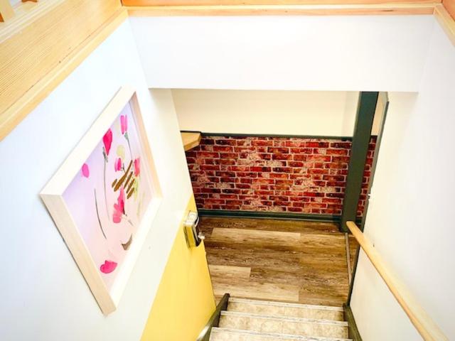 a view of a staircase with a brick wall at Banff International Hostel in Banff