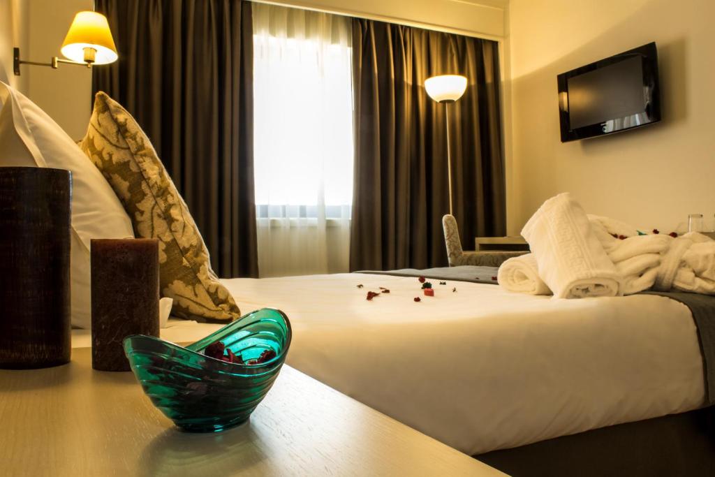 Cama ou camas em um quarto em Hotel Black Tulip - Porto Gaia