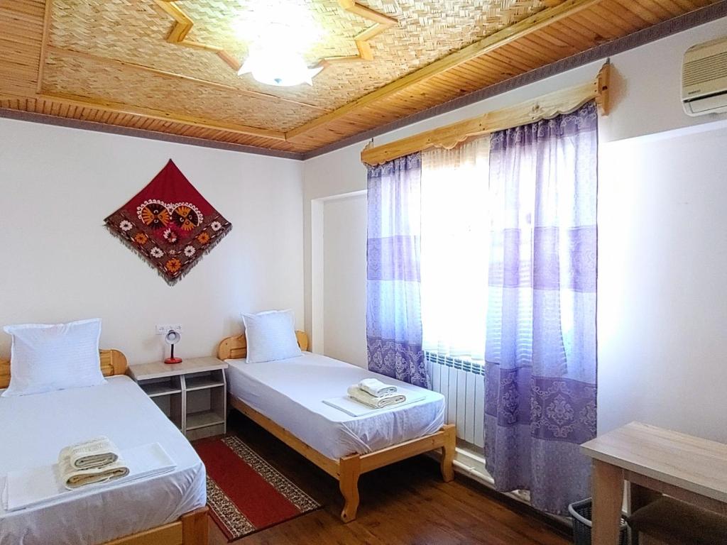 Postel nebo postele na pokoji v ubytování XIVA AZIM OTA