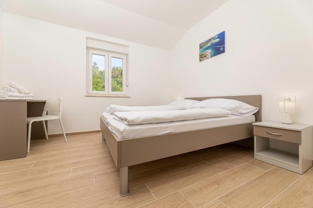 Кровать или кровати в номере Apartments Sucic 2