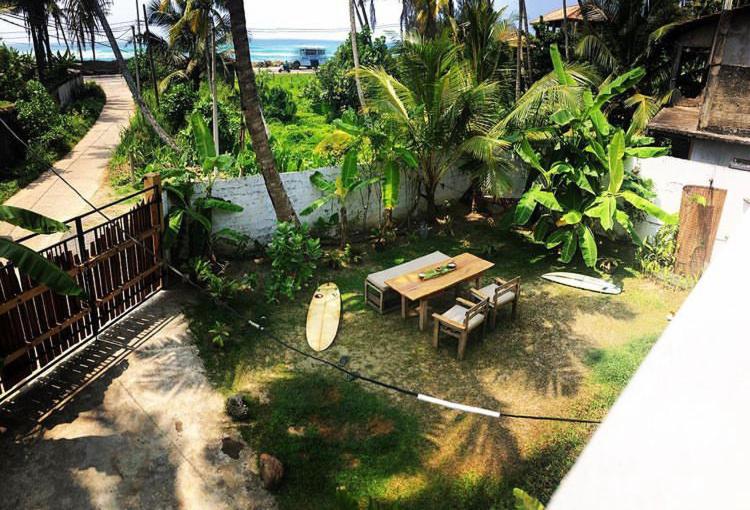 an overhead view of a patio with a table and a surfboard at Marshmallow Homestay in Ahangama