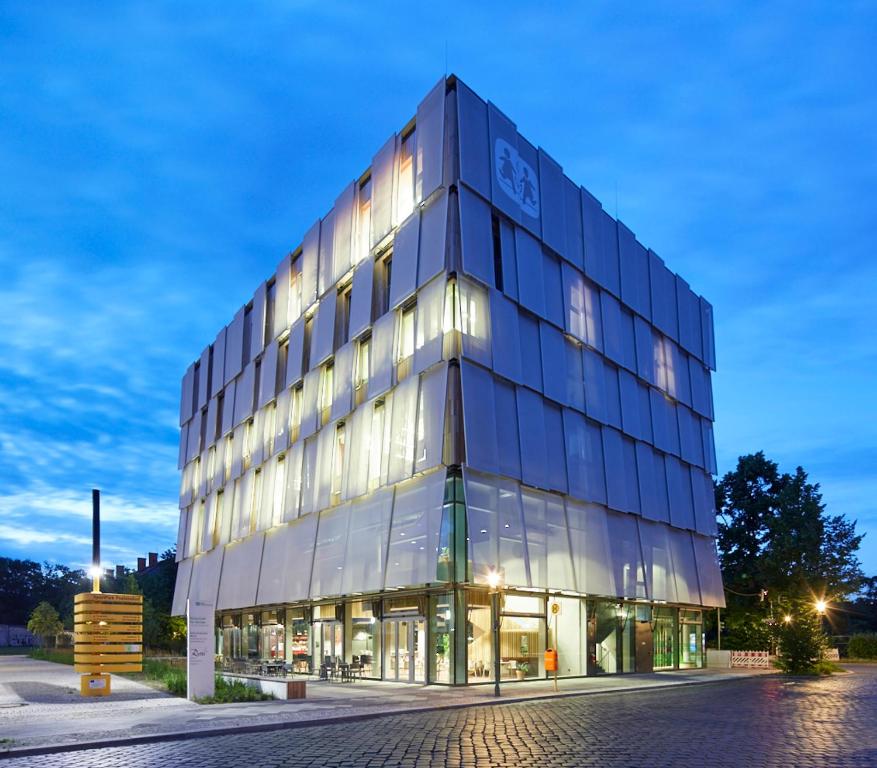 ein großes Glasgebäude mit vielen Fenstern in der Unterkunft Hotel Rossi in Berlin