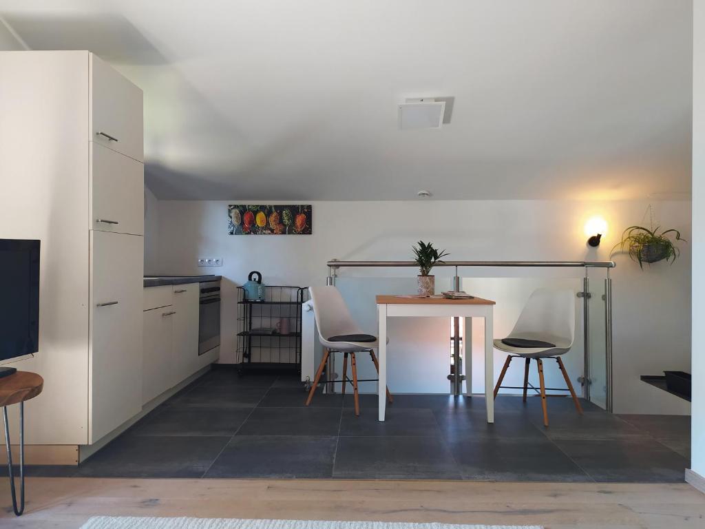 a kitchen and dining room with a table and chairs at Urlaub im schönen Nussdorf/Inn in Nußdorf am Inn